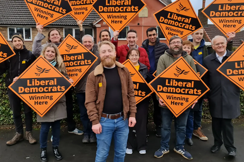 Councillor Alan Good surrounded by Lib Dem campaigners