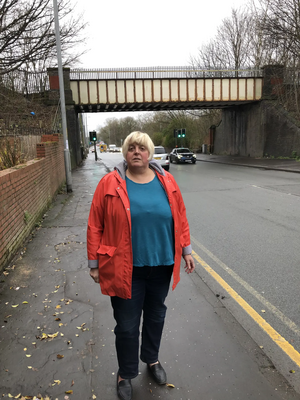 Jackie Pearcey at the Hyde Road Bridge to be demolished in the road widening.